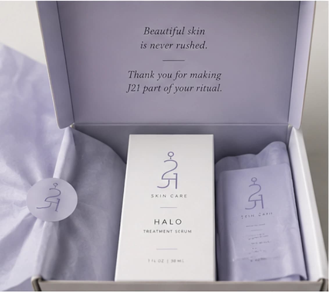 An open J21 box, the lid printed with Beautiful skin is never rushed.